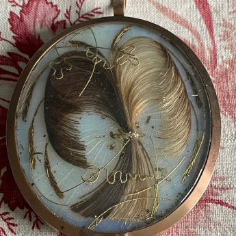 Isabella Beetham, silhouette painted on glass in locket frame